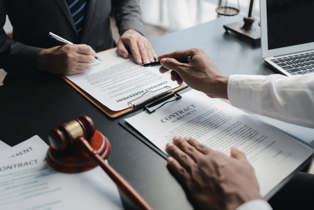 A Lawyer Guiding Another Person on a Contract Agreement.